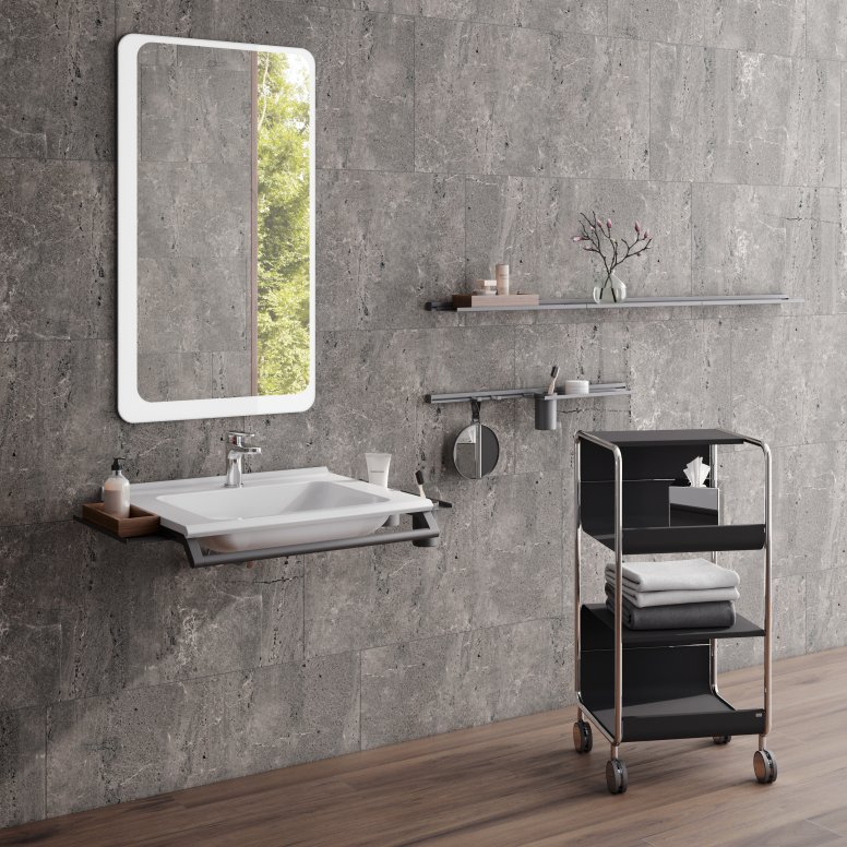 Modular washbasin with grab rail and shelves, side trolley next to it in the colour black matt